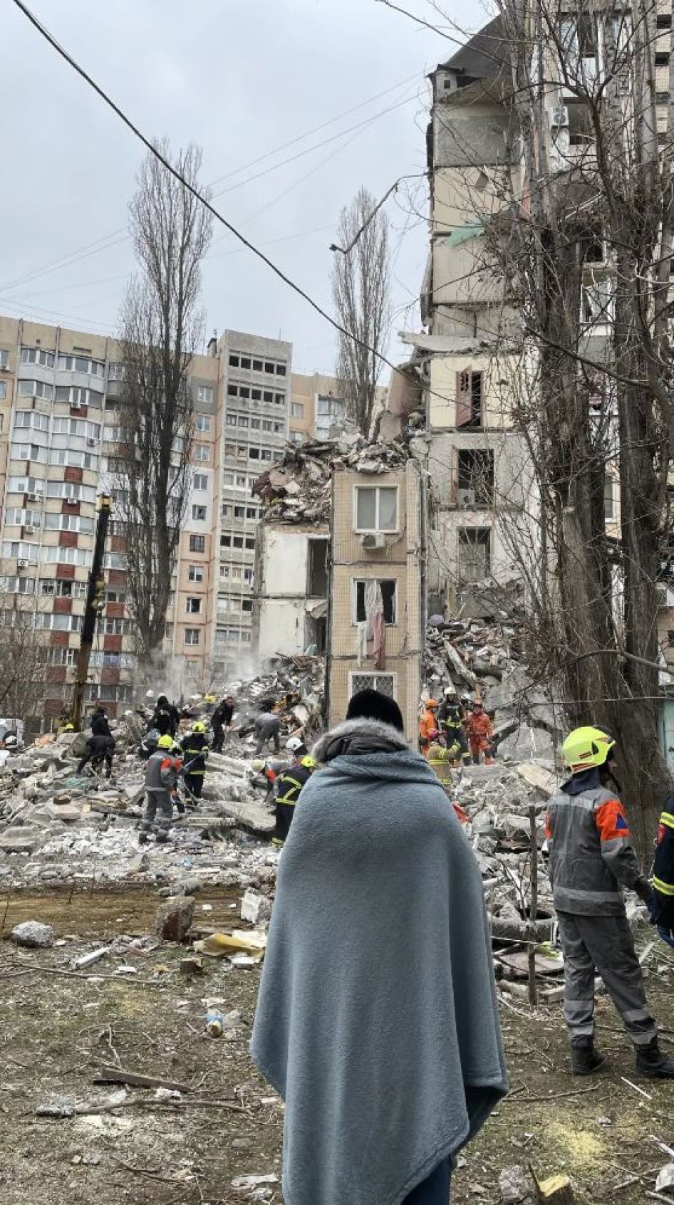 Serhii Gaidarzhi watches as rescue workers search for the bodies of his wife Anna Gaidarzhi and their four-month-old son Tymofii, both killed in the drone attack. Odesa, March 2, 2024.