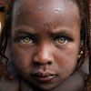 A girl displaced by fighting is embraced by her sister at the Abushouk camp in Darfur (Photo: Finbarr O'Reilly/Reuters).
