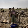 Women sort through the rubble where their house once stood, four weeks after Cyclone Nargis. 
� 2008 Panos