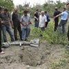 Georgians look at the remnants of an RBK-250 cluster bomb dropped by Russian aircraft on the village of Ruisi, near South Ossetia