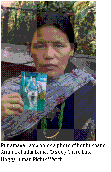 Text Box: 
Punamaya Lama holds a photo of her husband Arjun Bahadur Lama. © 2007 Charu Lata Hogg/Human Rights Watch

