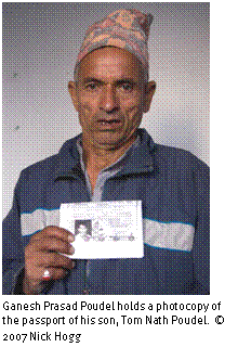 Text Box: 
Ganesh Prasad Poudel holds a photocopy of the passport of his son, Tom Nath Poudel. © 2007 Nick Hogg
