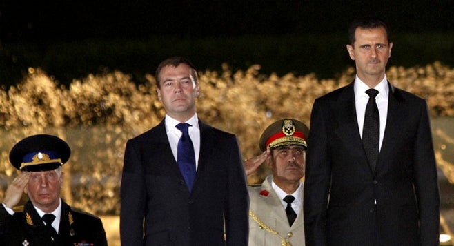 Syrias President Bashar al-Assad (R) and Russias President Dmitry Medvedev review the honor guards at al-Shaaeb presidential palace in Damascus, Syria on May 10, 2010. (Photo courtesy of Reuters)