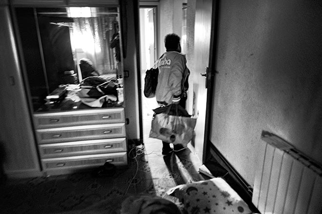 <p>A woman picks up her clothes from her room after receiving an eviction notice in Terrassa, Spain, October 19, 2012.</p>