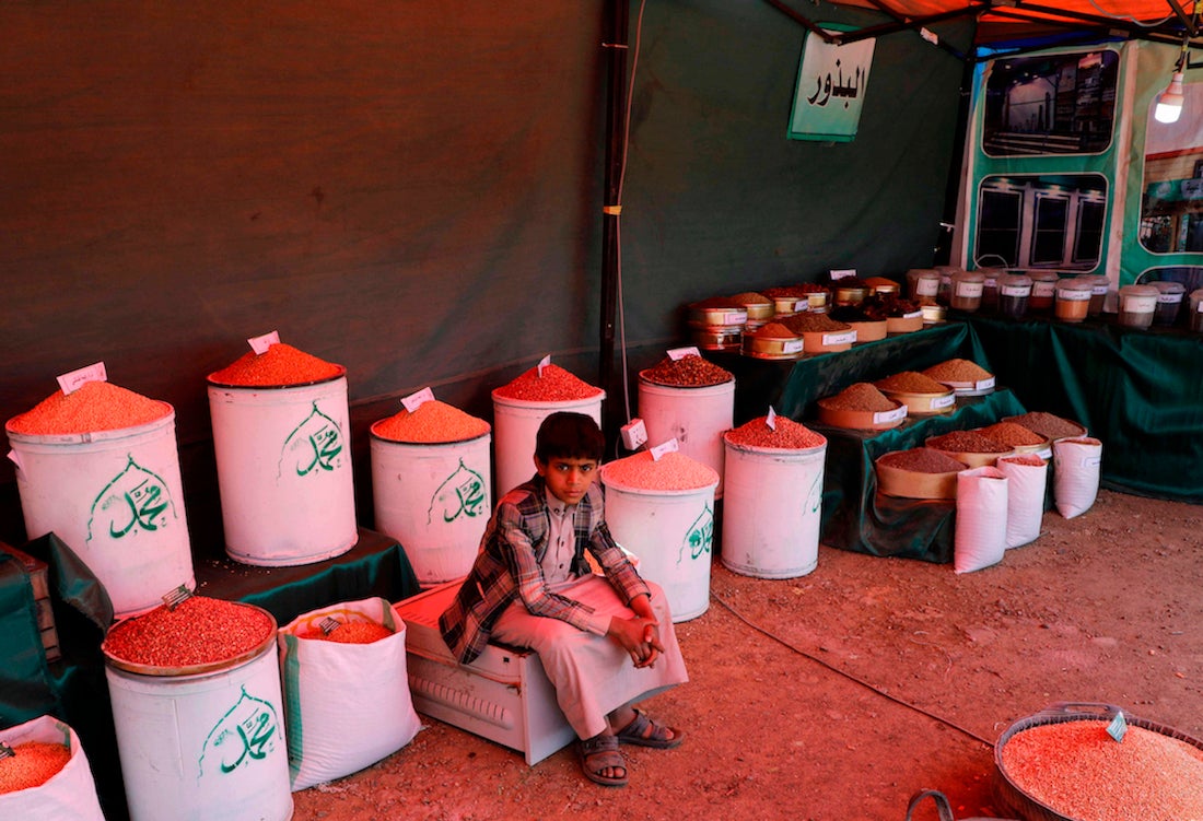 A Yemeni boy sits in a dry goods shop in a traditional market in Sanaa, Yemen.