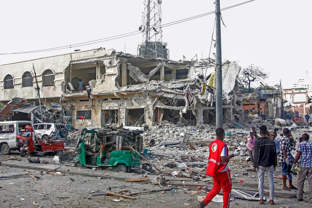 A destroyed building and vehicles after a double car bomb attack at a busy junction in Mogadishu, Somalia.