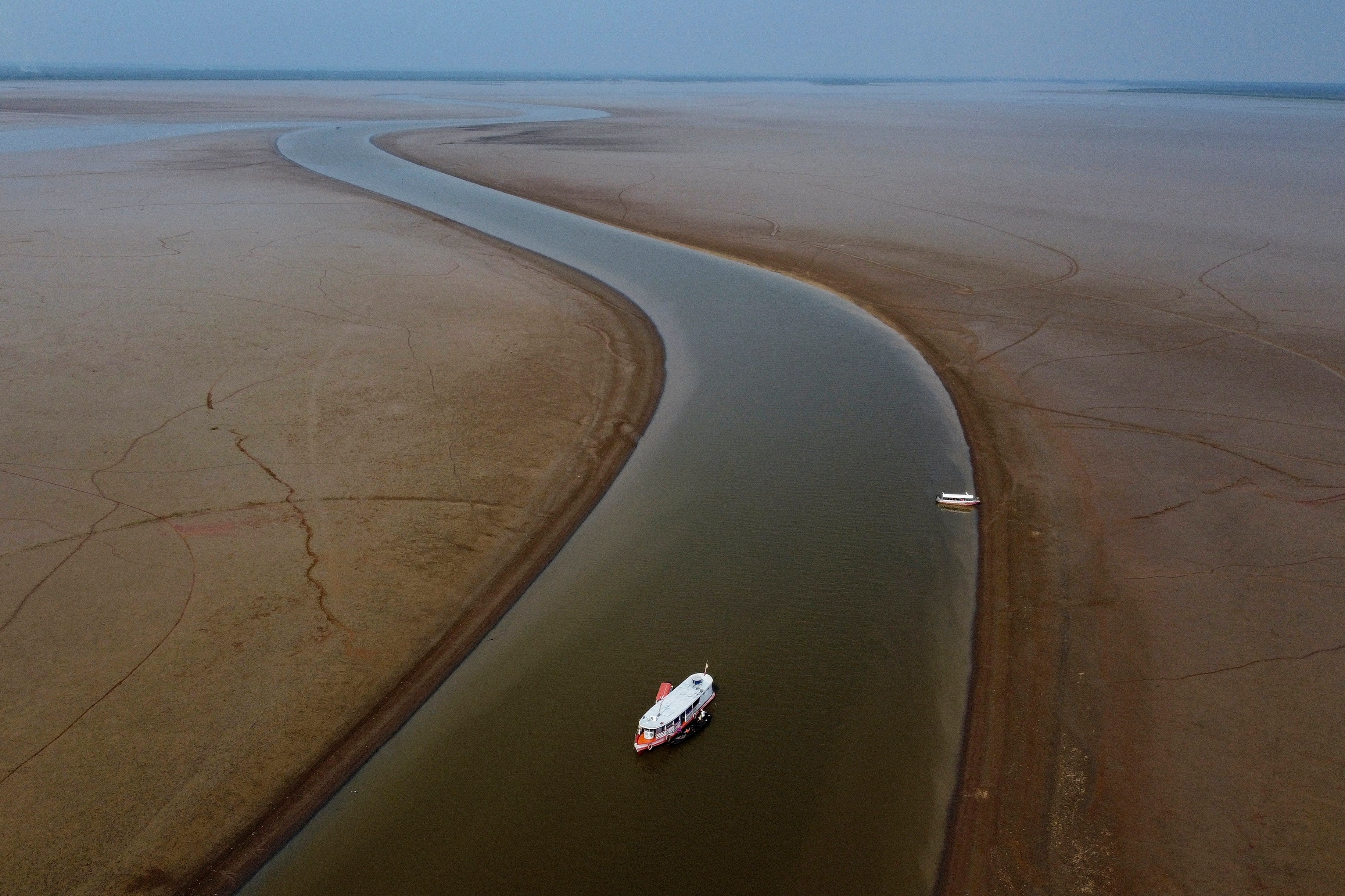 A boat travels through a section of the Amazon River affected by drought in Amazonas state, near Manacapuru, Brazil, September 27, 2023. 