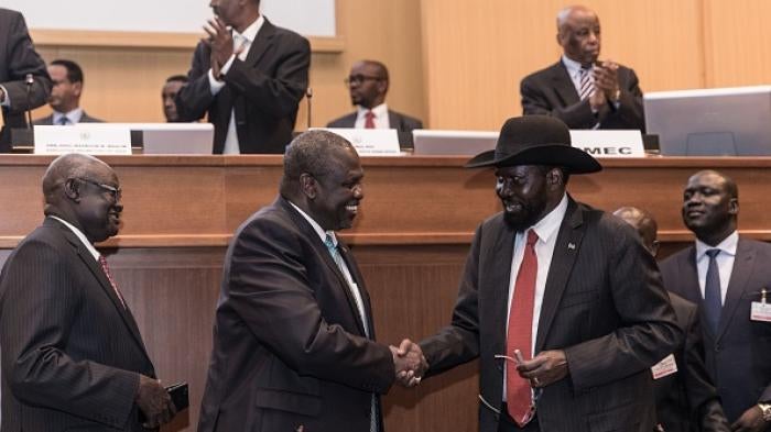 South Sudan's President Salva Kiir (2nd R) and his former deputy turned rebel leader Riek Machar (2nd L) shake hands as they make a last peace deal at the 33rd Extraordinary Summit of Intergovernmental Authority on Development (IGAD) in Addis Ababa on September 12, 2018.