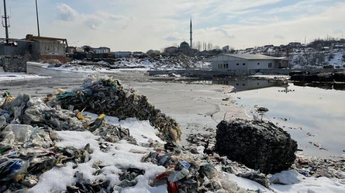 Illegally dumped plastic waste, including imported European plastic waste imports, near a residential neighborhood in Sultangazi, Istanbul, Turkey.