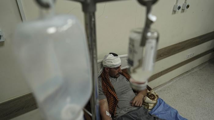 A member of an Iranian opposition party based in the Kurdistan Region of Iraq lies injured on a hospital bed following Iranian air attacks, September 28, 2022.