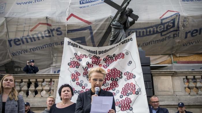 Joanna Scheuring-Wielgus, a social activist and politician, reads testimony from a child who was molested by a priest during a protest in Warsaw, October 7, 2018.