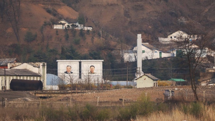 Portraits of Kim Jong Il and Kim Il Sung at the border