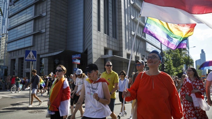 Belarusian LGBTQ activists with white-red-white flags participate in the Warsaw Equality Parade, June 25, 2022.
