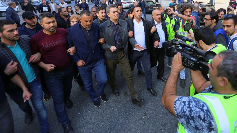 Head of the Popular Front Party of Azerbaijan Ali Karimli (C) and his supporters hold an unauthorized rally to demand the right to freedom of assembly, in Baku, Azerbaijan, October 19, 2019.