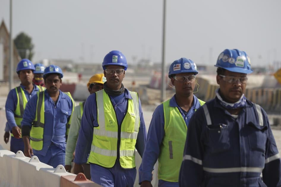 Des ouvriers marchent vers le stade de Lusail, l'un des stades de la Coupe du monde 2022, à Lusail, au Qatar, en décembre 2019.