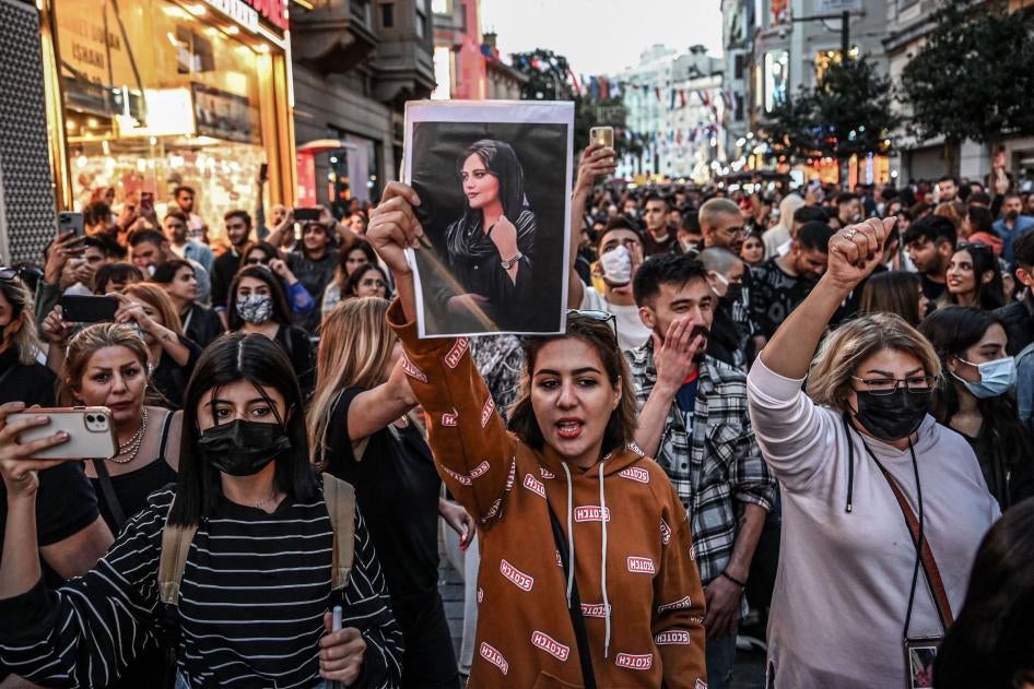 A protester in Istanbul, Turkey, holds a portrait of Mahsa (Jina) Amini during a demonstration on September 20, 2022.