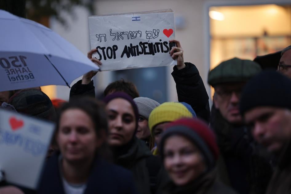 A demonstrator holds a sign during a vigil outside a community center and synagogue in Berlin, Germany, on October 20, 2023. 