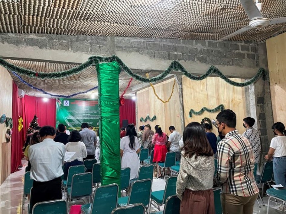 People worship during service inside a church in Jakarta