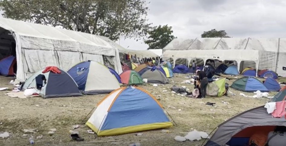 Several tents sit outside in a migrant center