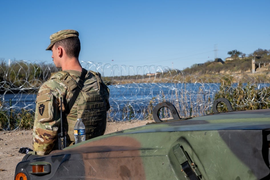 National Guard soldier stands guard on the banks of the Rio Grande river at Shelby Park in Eagle Pass, Texas on January 12, 2024.