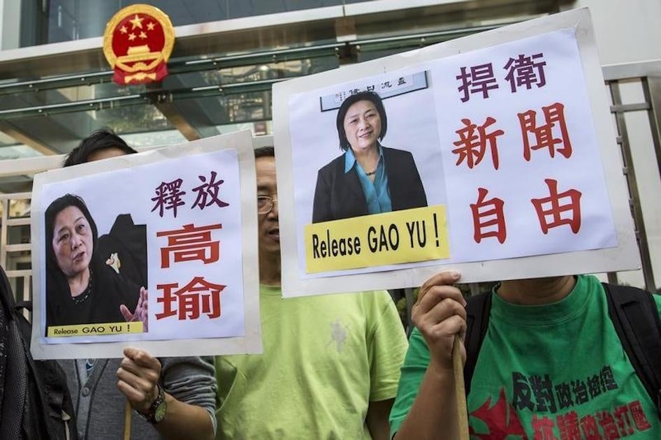Protesters hold up signs during a demonstration calling for the release of Chinese journalist Gao Yu in Hong Kong on April 17, 2015.