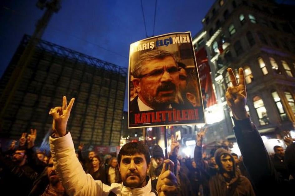 A demonstrator holds a picture of Bar Association President Tahir Elci during a protest in Istanbul, Turkey.