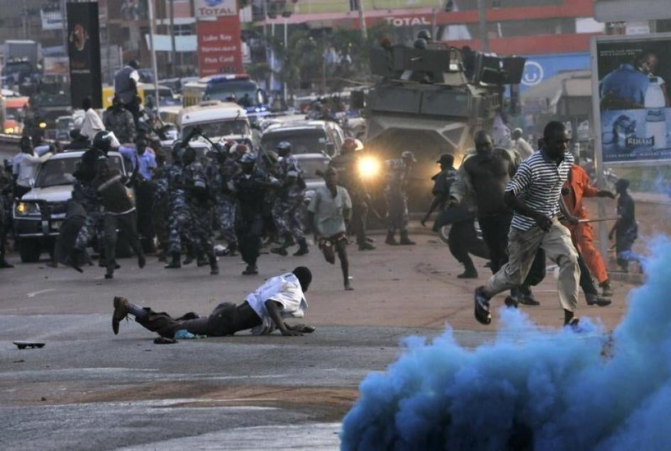 Anti-riot police fire canisters of colored teargas to disperse supporters of opposition Forum for Democratic Change during a procession to welcome their leader Kizza Besigye in Kampala on May 12, 2011.