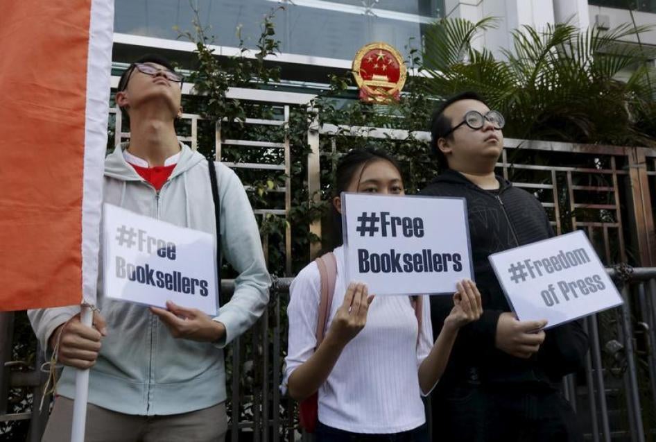 Members of student group Scholarism hold up placards during a protest about the disappearances of booksellers outside China's liaison office in Hong Kong, China January 6, 2016.