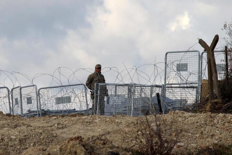 A border guard manning Turkey’s closed border with Syria patrols near the Turkish village of Guvecci, February 7, 2016. 