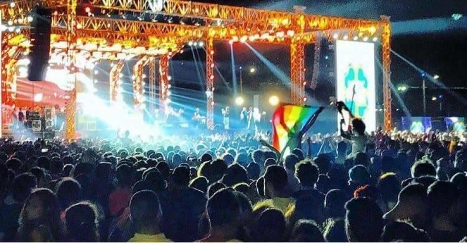 Young people wave a rainbow flag at a Cairo concert featuring the Lebanese Band Mashrou’ Leila. Activist Ahmed Alaa confirmed that he raised a rainbow flag at the concert in a Buzzfeed video including this image prior to his arrest. 