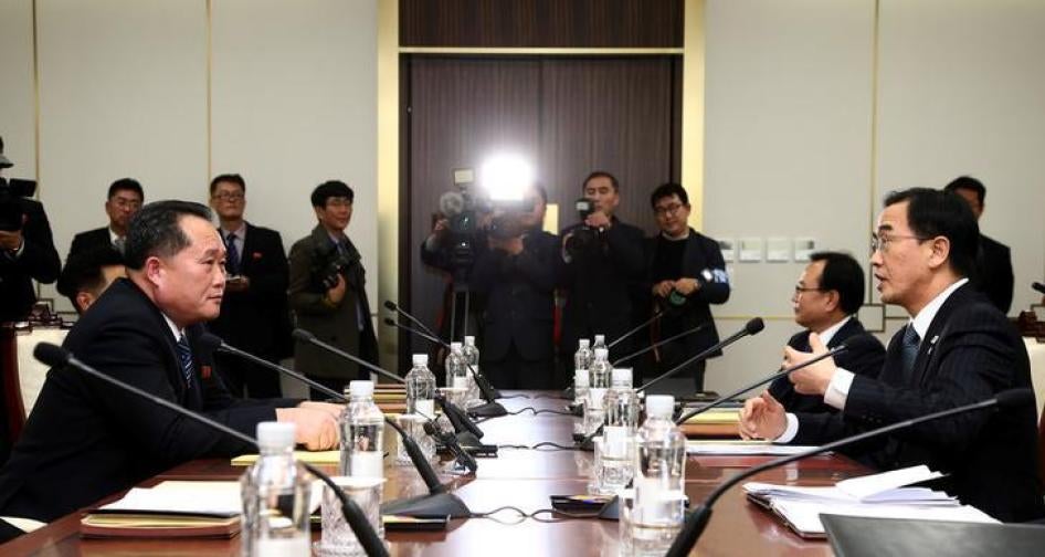 Head of the North Korean delegation, Ri Son Gwon talks with South Korean counterpart Cho Myoung-gyon during their meeting at the truce village of Panmunjom in the demilitarised zone separating the two Koreas, South Korea on January 9, 2018. 