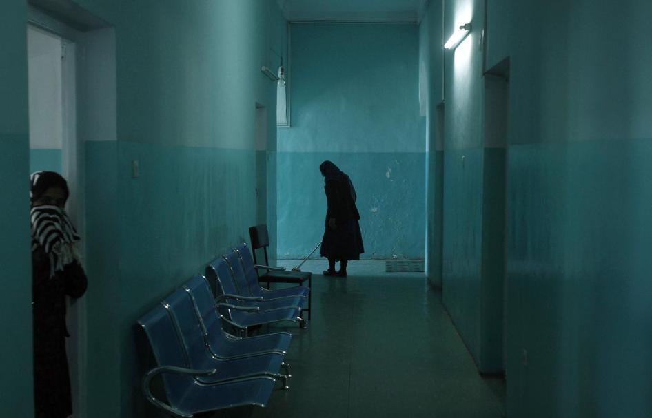 An employee cleans the corridor of the women's ward at the mental health hospital in Kabul, November 2012.