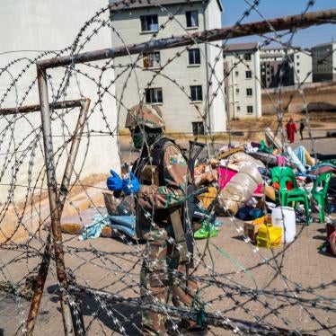 A South Africa soldier guards the entrance of a housing development while flats are being emptied in Johannesburg, South Africa, Wednesday Aug. 12, 2020.