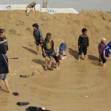 Children play in a mud puddle at Al-Hol camp, in the section where foreign families from Islamic State-held areas are housed in Syria, Sunday, March 31, 2019.