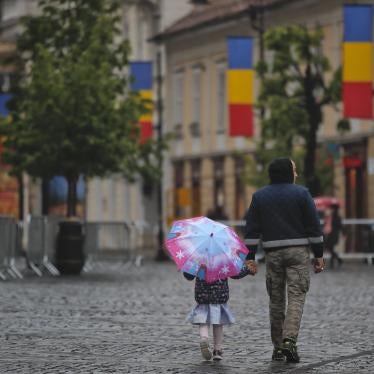 A little girl walks holding an umbrella in the Transylvanian town of Sibiu, Romania, Tuesday, May 7, 2019. (AP Photo/Vadim Ghirda)