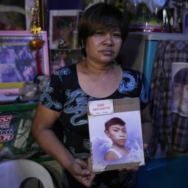Mother holding a photo of her deceased son.