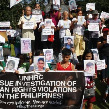 Families of victims of extrajudicial killings in the "war on drugs" display portraits of their slain relatives and call on the UN Human Rights Council to investigate the killings, in Quezon City, Philippines, July 9, 2019.