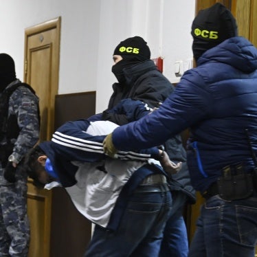 Federal Security Service officials bring Dalderjon Mirzoev, a suspect in the Crocus City Hall's massacre, to the Basmanny District Court in Moscow on March 24, 2024. 