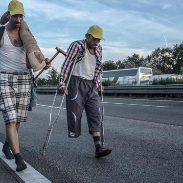 Safi, 30, (right) a Syrian refugee from Aleppo, walks on highway M1 near Budapest, Hungary in an attempt to reach Vienna, Austria by foot.