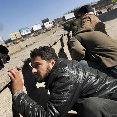 Afghan journalists seek cover in Kabul on Jan. 18, 2010 during a series of co-ordinated attacks by Taliban militants in the Afghan capital that killed at least 10 people and injured 32.