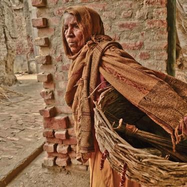  Gangashree walks through the village to manually clean human excrement from dry toilets in Kasela, Uttar Pradesh, which she will collect in her basket and carry to the outskirts of the village for disposal. 