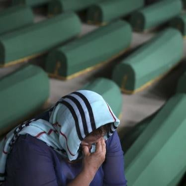 A woman cries near the coffin of her relative among 136 newly identified victims of the 1995 Srebrenica genocide.