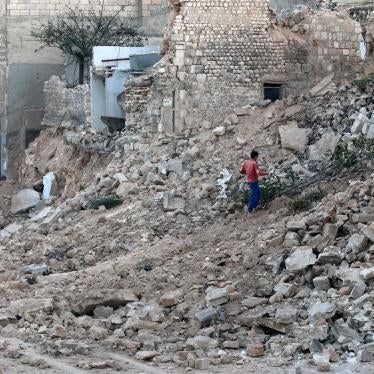 A civilian collects tree branches from the rubble of a damaged site in Aleppo’s rebel-held besieged Qadi Askar neighbourhood.