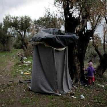 A girl walks next to a self-made shower at a makeshift camp for refugees and migrants next to the Moria camp on the island of Lesbos, Greece, November 30, 2017.
