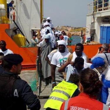 Migrants disembark from the SOS Mediterranee ship Aquarius at the Italian island of Lampedusa, April 18, 2016.