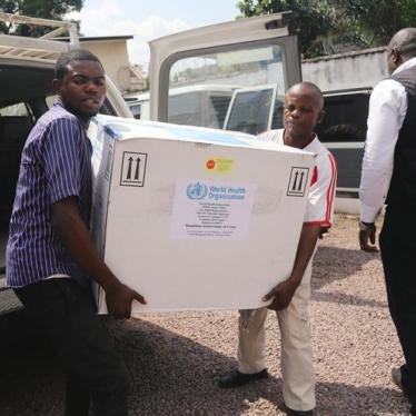 Congolese Health Ministry officials carry the first batch of experimental Ebola vaccines in Kinshasa, Democratic Republic of Congo, May 16, 2018.