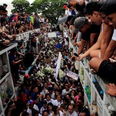 Mourners watch as Kian delos Santos, a 17-year-old student who was shot during anti-drug operations, is buried in Metro Manila, Philippines, August 26, 2017.