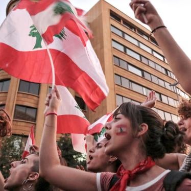 Women shout slogans and wave the Lebanese flag during a demonstration in down town Beirut.