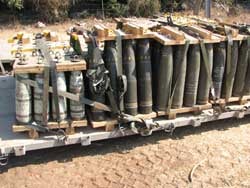 Pallets of 155mm artillery projectiles including DPICM cluster munitions (center and right with yellow diamonds) in the arsenal of an IDF artillery unit on July 23 in northern Israel.  Each DPICM shell contains 88 sub-munitions, which have a dud rate of up to 14 percent. © Human Rights Watch 2006