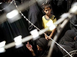 Iraqis wait for information about relatives detained at Abu Ghraib prison, May 14, 2004